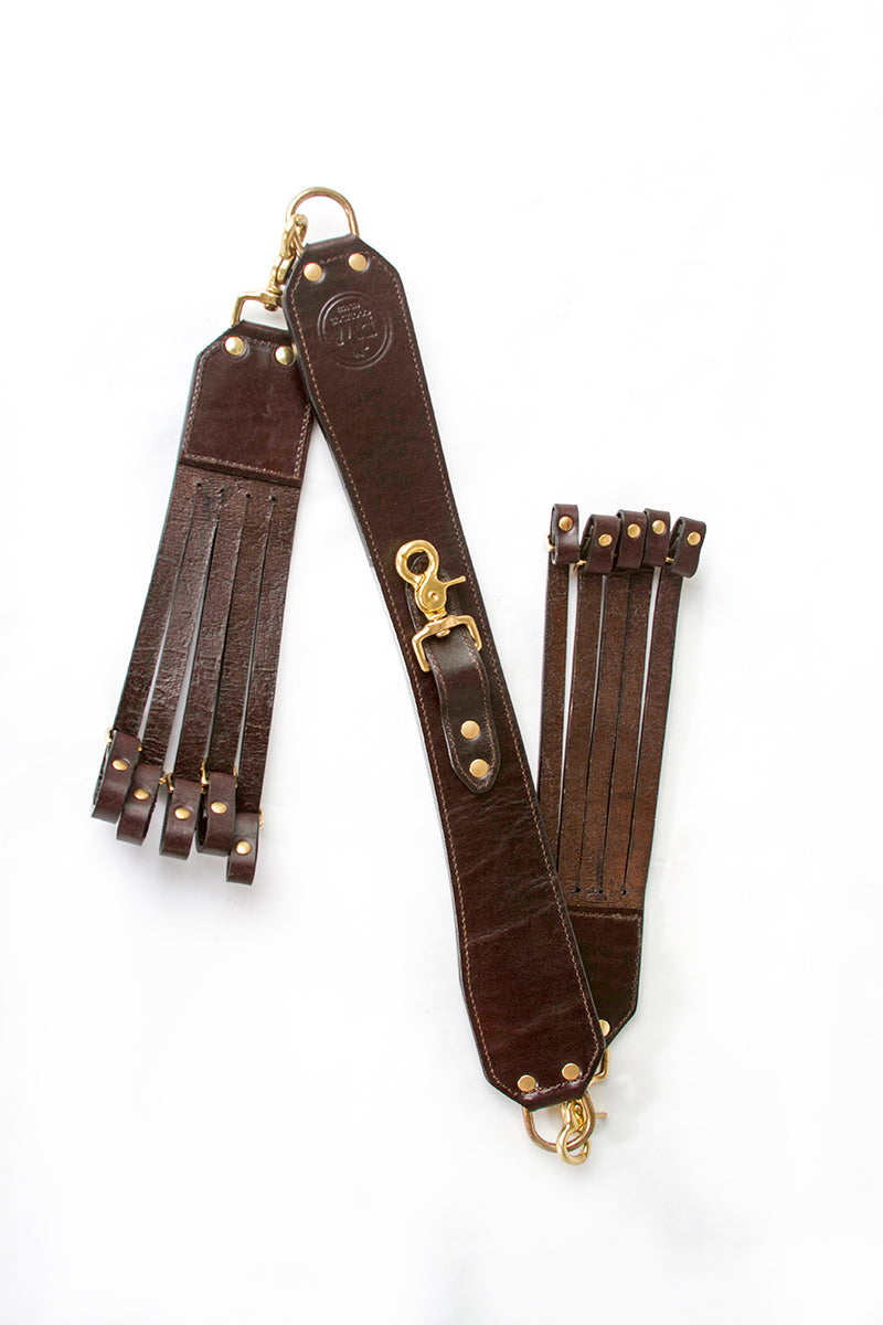 RW Coolidge Leather Duck Strap Guide Series flat lay showing both clips, brass hardware, and stitching detail