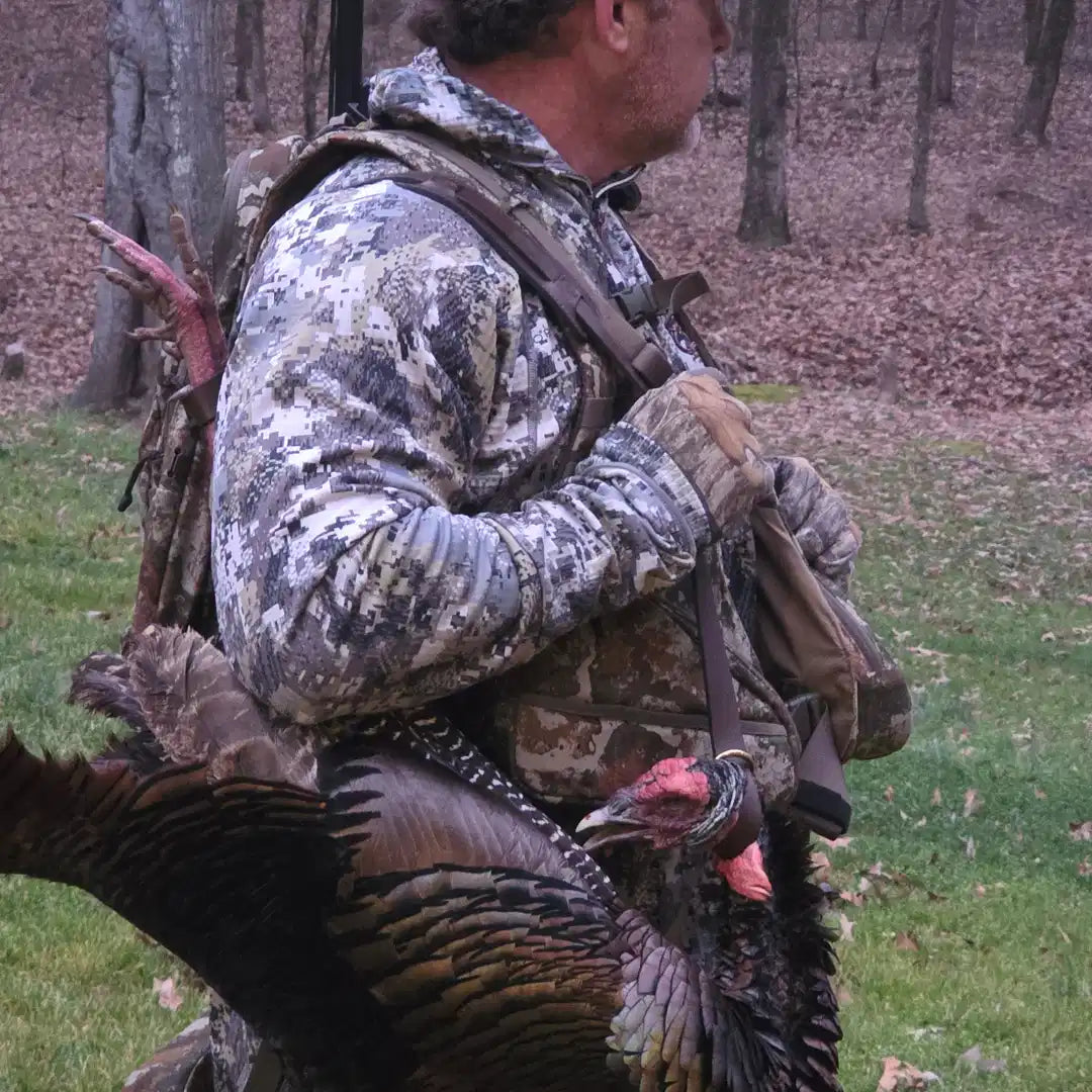 Hands-Free Carry variant — turkey carried over shoulder while walking through timber