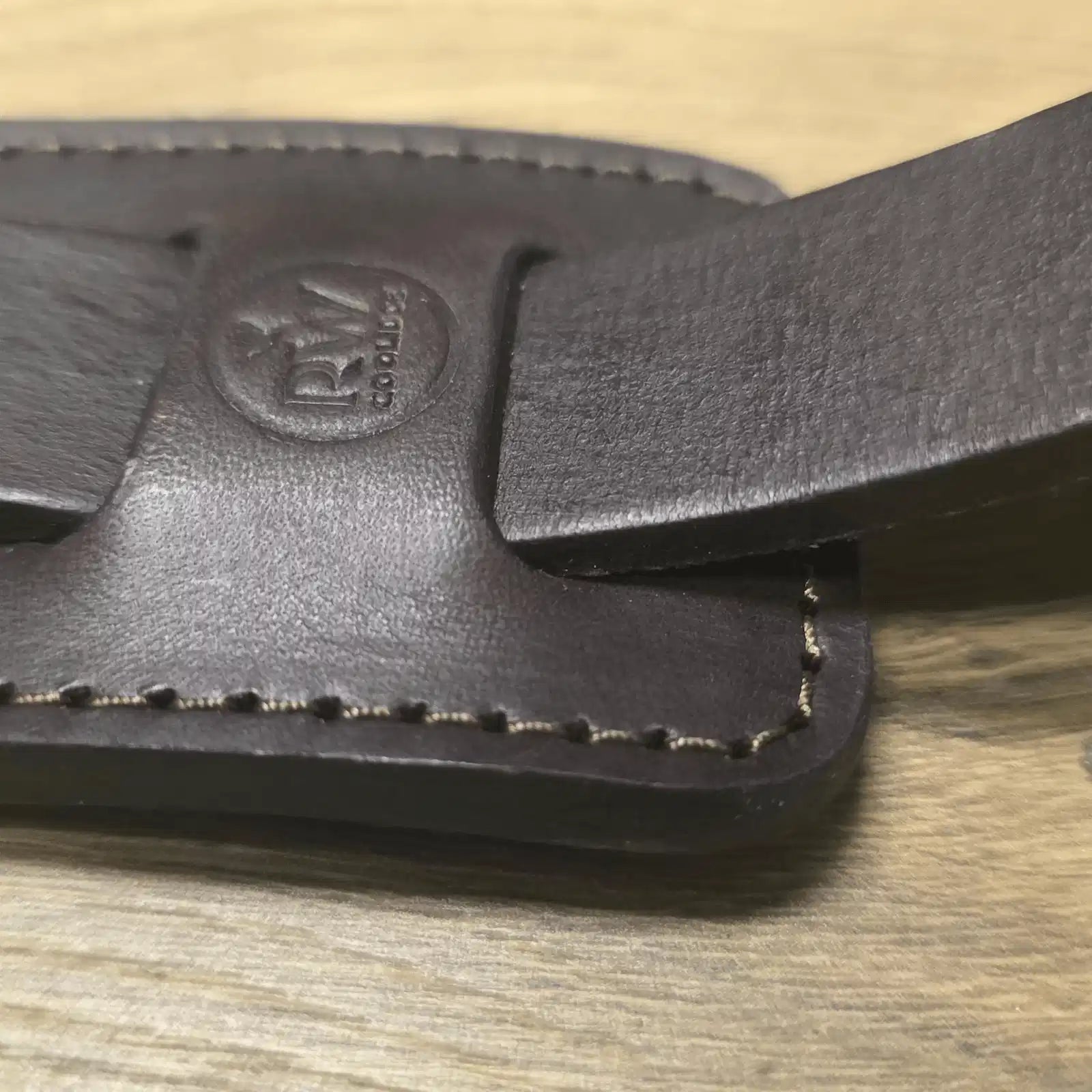 Close-up of RW Coolidge logo stamp and hand-stitched leather