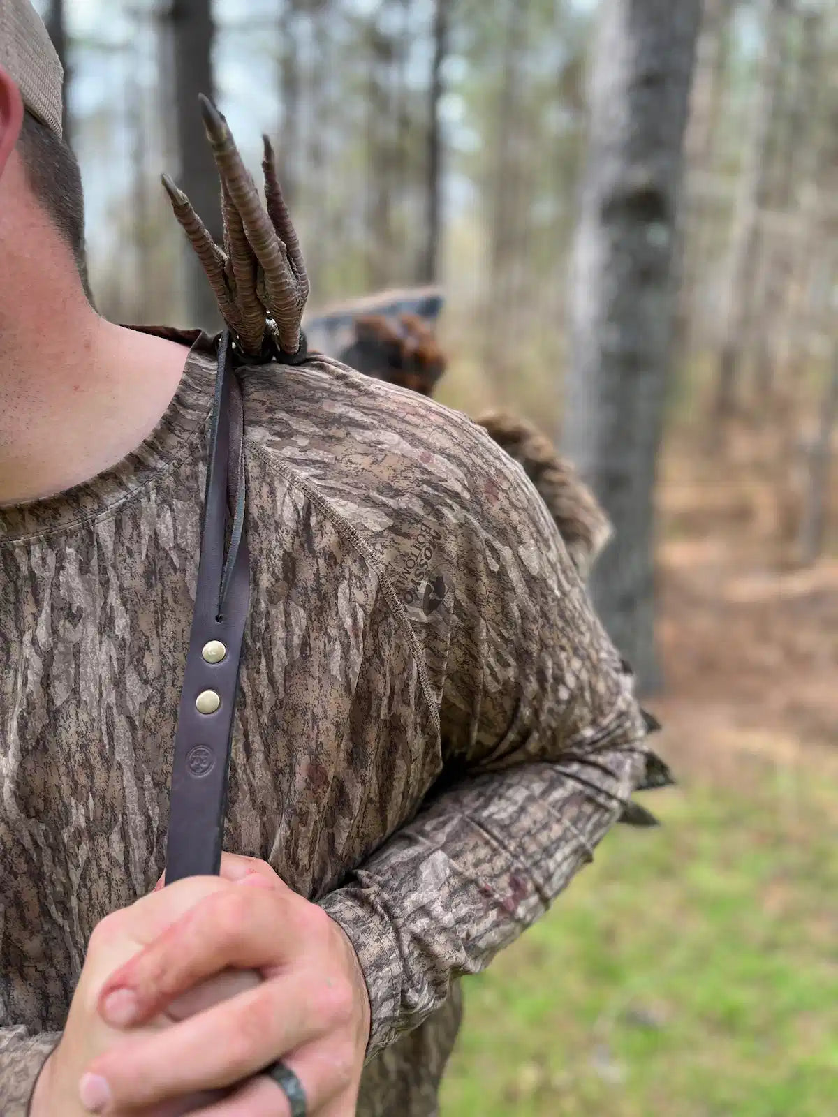 Single-Hand Carry variant in use — hunter carrying turkey by hand