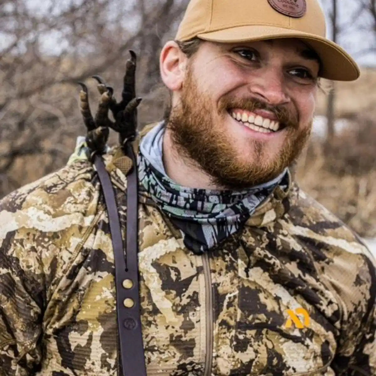 Hunter smiling with single-hand turkey tote — talons visible over shoulder